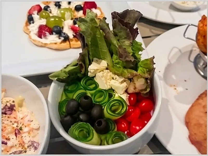 Plated salads and sides ready for service